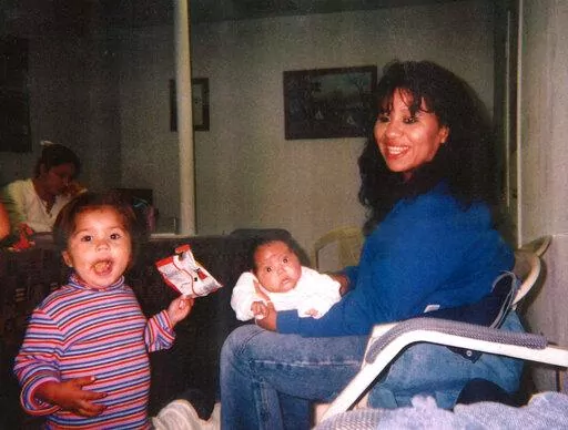 In this undated photograph, Texas death row inmate Melissa Lucio is holding her daughter Mariah, while one of her other daughters, Adriana, stands next to them. Lucio is set to be executed on April 27 for the 2007 death of Mariah. Prosecutors say Lucio fatally beat her 2-year-old daughter but Lucio has long denied that, saying Mariah died from injuries sustained during a fall down a flight of stairs. Her lawyers say Lucio's history of sexual and physical abuse led to her giving an unreliable con