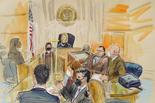 This artist sketch depicts Judge Dabney Friedrich looking out from the bench during jury selection for Guy Wesley Reffitt, joined by his lawyer William Welch, top right, in Federal Court, in Washington, Monday, Feb. 28, 2022. Seated from front left are members of the U.S. prosecution legal team, Tim Ryan, Risa Berkower, Jeff Nestler, and Amanda Rohde. Reffitt, a Texas man charged with storming the U.S. Capitol with a holstered handgun on his waist, is the first Jan. 6 defendant to go on trial. (