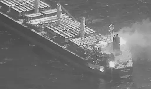 This black-and-white image released by the U.S. military's Central Command shows the fire aboard the bulk carrier True Confidence after a missile attack by Yemen's Houthi rebels in the Gulf of Aden on Wednesday, March 6, 2024. A missile attack by Yemen's Houthi rebels on a commercial ship in the Gulf of Aden on Wednesday killed three of its crew members and forced survivors to abandon the vessel, the U.S. military said. It was the first fatal strike in a campaign of assaults by the Iranian-backe