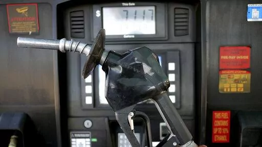 A gasoline pump is shown at a gas station Friday, June 10, 2022, in Salt Lake City.  With record-high gas prices, travelers can save money on summer road trips by considering alternatives. They can plan a trip to U.S. regions with lower-cost fuel, like the Midwest or South. If travelers need to rent a car, they might find affordable options by going to a cheaper car rental location or considering a car rental alternative like car sharing. With more hotels offering electric vehicle charging, rent
