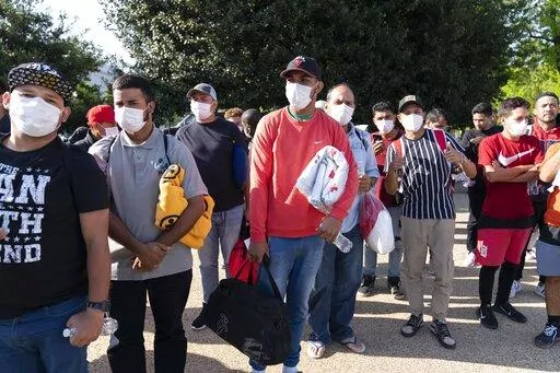 Migrants hold Red Cross blankets after arriving at Union Station near the U.S. Capitol from Texas on buses, April 27, 2022, in Washington.  The Pentagon has rejected a request from the District of Columbia seeking National Guard assistance for the thousands of migrants being bused to the city from two southern states. (AP Photo/Jose Luis Magana, File)