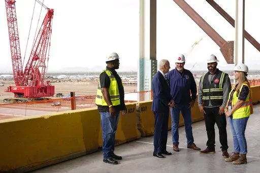 President Joe Biden tours the building site for a new computer chip plant for Taiwan Semiconductor Manufacturing Company, Tuesday, Dec. 6, 2022, in Phoenix. (AP Photo/Patrick Semansky)