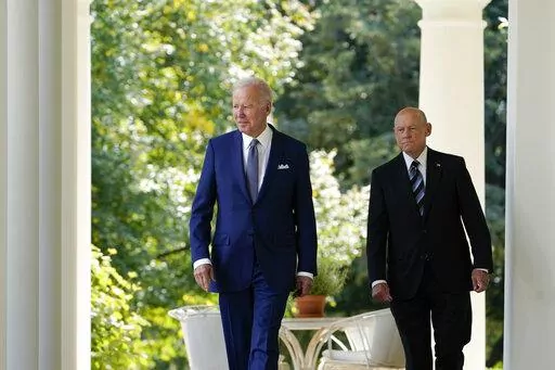 President Joe Biden walks with Bob Parant, Medicare beneficiary with Type 1 diabetes, as they arrive to speak at an event on health care costs, in the Rose Garden of the White House, Tuesday, Sept. 27, 2022, in Washington. (AP Photo/Susan Walsh)