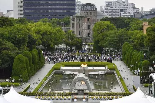 Doves fly over the cenotaph dedicated to the victims of the atomic bombing during the ceremony marking  the 77th anniversary of the world's first atomic bombing, at the Hiroshima Peace Memorial Park in Hiroshima, western Japan Saturday, Aug. 6, 2022. (Kyodo News via AP)