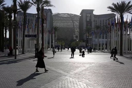 People walk through the venue at the COP28 U.N. Climate Summit near the Al Wasl Dome at Expo City, Thursday, Nov. 30, 2023, in Dubai, United Arab Emirates. (AP Photo/Rafiq Maqbool, File)