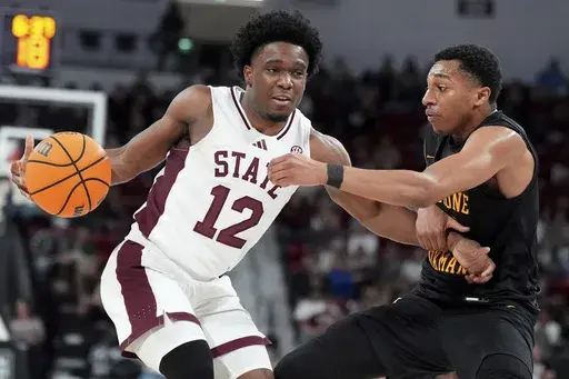 Mississippi State guard Josh Hubbard (12) fights off a steal-attempt by Bethune-Cookman guard Seneca Willoughby, right, during the first half of an NCAA college basketball game, Monday, Dec. 30, 2024, in Starkville, Miss. (AP Photo/Rogelio V. Solis)