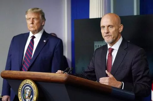 President Donald Trump listens as Dr. Stephen Hahn, commissioner of the U.S. Food and Drug Administration, speaks during a media briefing in the James Brady Briefing Room of the White House, Aug. 23, 2020, in Washington. Officials in the Trump White House tried to pressure U.S. health experts into reauthorizing a discredited COVID-19 treatment, according to a congressional investigation that provides new evidence of that administration’s efforts to override Food and Drug Administration decisio