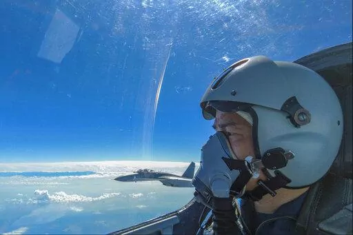 In this photo released by Xinhua News Agency, an air force pilot from the Eastern Theater Command of the Chinese People's Liberation Army (PLA) looks as they conduct a joint combat training exercises around the Taiwan Island on Sunday, Aug. 7, 2022. China said Monday it was extending threatening military exercises surrounding Taiwan that have disrupted shipping and air traffic and substantially raised concerns about the potential for conflict in a region crucial to global trade. (Wang Xinchao/Xi