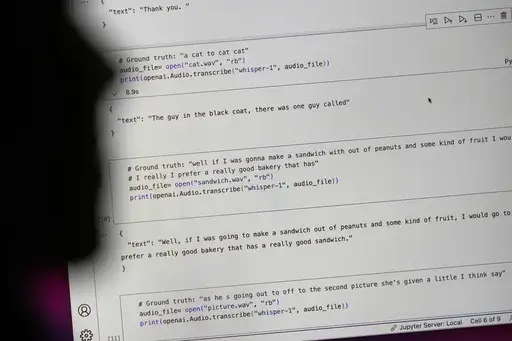 Assistant professor of information science Allison Koenecke, an author of a recent study that found hallucinations in a speech-to-text transcription tool, works in her office at Cornell University in Ithaca, N.Y., Friday, Feb. 2, 2024. The text preceded by "#Ground truth" shows what was actually said while the sentences preceded by ""text"" was how the transcription program interpreted the words. (AP Photo/Seth Wenig)