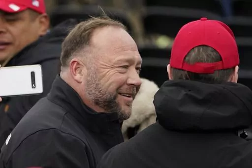 Alex Jones, left, attends a rally in support of President Donald Trump called the "Save America Rally," on Jan. 6, 2021, in Washington. Elon Musk has restored the X account of conspiracy theorist Alex Jones following a poll posted on the social media platform formerly known as Twitter on Saturday Dec. 9, 2023 that came out in favor of the Infowars host who repeatedly called the 2012 Sandy Hook school shooting a hoax. (AP Photo/Jacquelyn Martin, File)