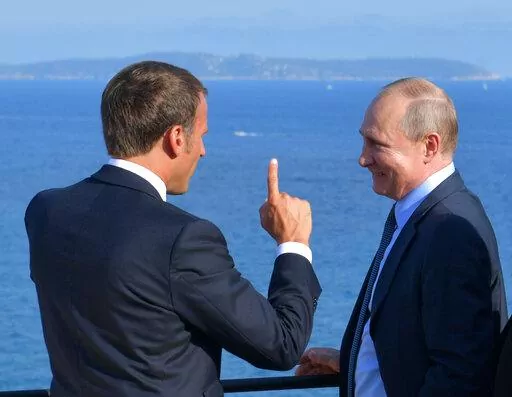French President Emmanuel Macron, left, talks with Russian President Vladimir Putin during their meeting at the fort of Bregancon in Bormes-les-Mimosas, southern France, Monday Aug. 19, 2019. (Alexei Druzhinin, Sputnik, Kremlin Pool Photo via AP, File)