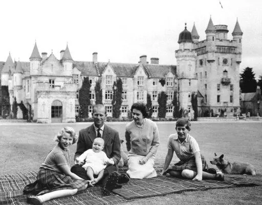 In this Sept. 1960, photo, Britain's Queen Elizabeth II, Prince Philip and their children, Prince Charles, right, Princess Anne and Prince Andrew, pose for a photo on the lawn of Balmoral Castle, in Scotland. When the hearse carrying Queen Elizabeth II's body pulled out of the gates of Balmoral Castle on Sunday, Sept. 11, 2022, it marked the monarch's final departure from a personal sanctuary where she could shed the straitjacket of protocol and ceremony for a few weeks every year. The sprawling