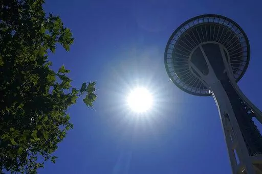 The sun shines near the Space Needle, Monday, June 28, 2021, in Seattle as Seattle and other cities broke all-time heat records, with temperatures soaring well above 100 degrees Fahrenheit (37.8 Celsius). Weather extremes like this will increase in frequency and intensity in North America the coming years as global warming accelerates, according to a United Nations Intergovernmental Panel on Climate Change report. (AP Photo/Ted S. Warren,File)