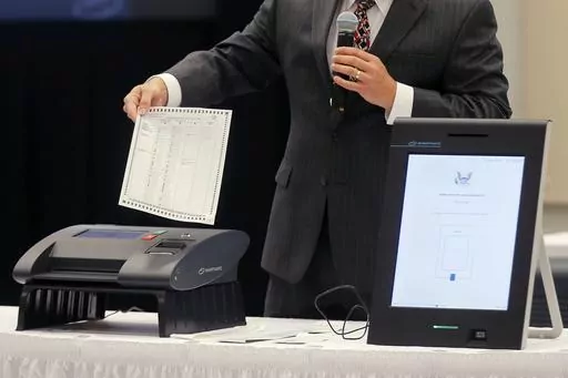 A Smartmatic representative demonstrates his company's system which has scanners and touch screens with printout options, at a meeting of the Secure, Accessible & Fair Elections Commission on Aug. 30, 2018, in Grovetown, Ga. Fox News agreed Wednesday, April 26, 2023, to hand over reams of documents produced during the just-settled defamation lawsuit between Dominion Voting Machines to another voting technology firm, Smartmatic, which in a $2.7 billion suit accuses the cable news giant of damagin
