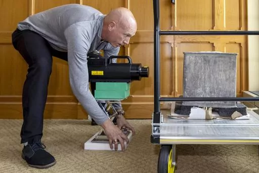 In this photo provided by the U.S. Military Academy at West Point, Kenneth Allen, professor of nuclear engineering, conducts an X-ray on a time capsule, Friday, June 9, 2023. The long-forgotten time capsule, a small lead box measuring about a cubic foot, was discovered in May 2023, during restoration to a monument honoring Revolutionary War hero Thaddeus Kosciuszko on the grounds of West Point, in New York. The box will be opened during a livestreamed event, Monday, Aug. 28. (Christopher Hennen/