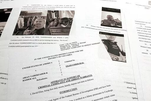 The affidavit to support the arrest of Arian Taherzadeh and Haider Ali is photographed Wednesday, April 6, 2022. Federal prosecutors have charged the two men they say were posing as federal agents, giving free apartments and other gifts to U.S. Secret Service agents, including one who worked on the first lady's security detail. Both were taken into custody as more than a dozen FBI agents charged into a luxury apartment building in Southeast Washington on Wednesday evening. (AP Photo/Jon Elswick)