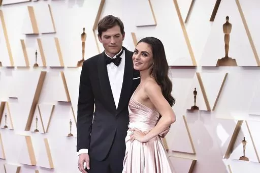 Ashton Kutcher, left, and Mila Kunis arrive at the Oscars on Sunday, March 27, 2022, at the Dolby Theatre in Los Angeles. The couple are apologizing for character letters they wrote on behalf of actor Danny Masterson ahead of this week's sentencing of their fellow "That '70s Show" cast member. A judge in Los Angeles on Thursday, Sept. 7, 2023, sentenced Masterson to 30 years to life in prison for raping two women in 2003. (Photo by Jordan Strauss/Invision/AP, File)