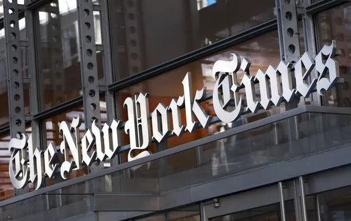 FILE - A sign for The New York Times hangs above the entrance to its building May 6, 2021, in New York. A New York judge has upheld an order preventing the Times from publishing documents between conservative group Project Veritas and its lawyer and ruled that the newspaper must immediately relinquish confidential legal memos it obtained. The decision Thursday, Dec. 23, by State Supreme Court Justice Charles D. Wood in Westchester County, released Friday, comes in a defamation lawsuit Project Ve