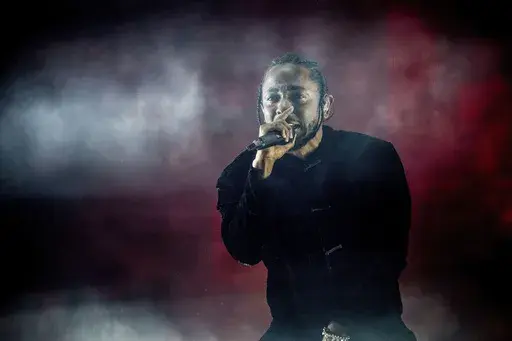 Kendrick Lamar performs at Coachella Music & Arts Festival at the Empire Polo Club on Sunday, April 16, 2017, in Indio, Calif. Kendrick Lamar turned his Juneteenth “Pop Out” concert into a celebration of Los Angeles unity. The 37-year-old rapper curated a three-hour livestreamed concert featuring a mix of up-and-coming LA rappers and stars including Dr. Dre and Tyler, The Creator. (Photo by Amy Harris/Invision/AP, File)