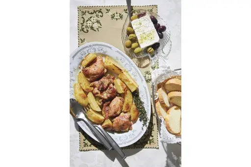 This image released by Harvest shows a recipe for Greek chicken from "The League of Kitchens Cookbook: Brilliant Tips, Secret Methods & Favorite Family Recipes from Around the World" by Lisa Kyung Gross. (Kristin Teig/Harvest via AP)
