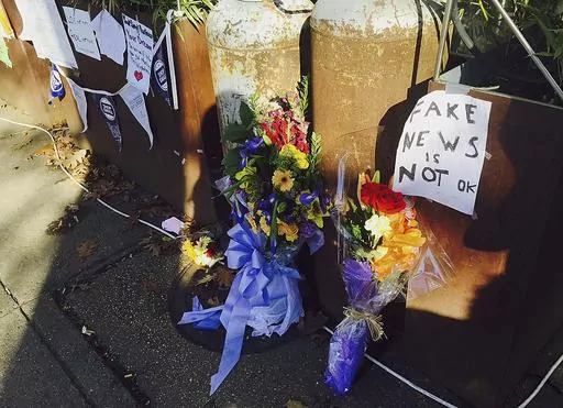 In this Dec. 9, 2016 photo, flowers and notes left by well-wishers outside a pizza restaurant in northwest Washington, D.C.,are shown, where a North Carolina man fired an assault rifle multiple times as he attempted to "self-investigate" the conspiracy theory known as "Pizzagate. On Friday, Dec. 1, 2023, The Associated Press reported on stories circulating online incorrectly claiming an expert who debunked the “pizzagate” conspiracy theory has been jailed for possessing child sexual abuse im