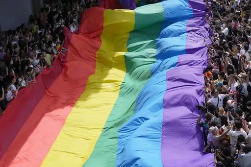 Participants hold a rainbow flag during a Pride Parade in Bangkok, Thailand, on June 4, 2023. Lawmakers in Thailand's lower house of Parliament overwhelmingly approved a marriage equality bill on Wednesday, March 27, 2024, that would make the country the first in Southeast Asia to legalize equal rights for marriage partners of any gender. (AP Photo/Sakchai Lalit, File)