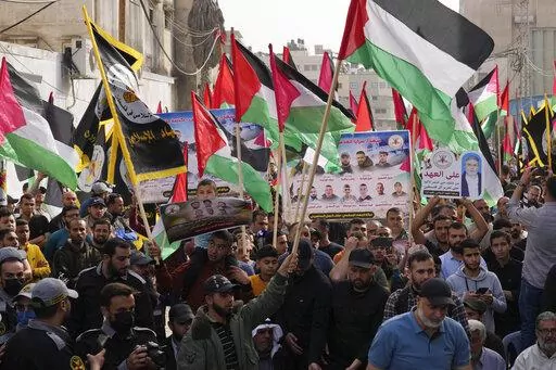 Islamic Jihad actives wave their national flags during a rally to mark Al-Quds, or Jerusalem, Day at the main road in Gaza City, Friday, April 29, 2022. (AP Photo/Adel Hana)