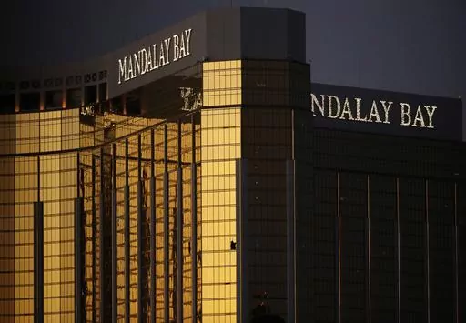 Broken windows from the Mandalay Bay resort and casino room from where Stephen Paddock fired on a nearby music festival are shown in Las Vegas, Oct. 3, 2017. Paddock a high-roller gambler who opened fire in 2017 on concertgoers in Las Vegas had lost tens of thousands of dollars while gambling weeks before the mass shooting and was upset with the way the casinos had been treating him, according to FBI documents made public this week. (AP Photo/John Locher, File)