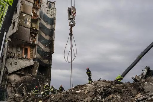 Firefighters work on a destroyed apartment building in the town of Borodyanka, Ukraine, on Saturday, April 9, 2022. Russian troops occupied the town of Borodyanka for weeks. Several apartment buildings were destroyed during fighting between the Russian troops and the Ukrainian forces in the town around 40 miles northwest of Kiev. (AP Photo/Petros Giannakouris)