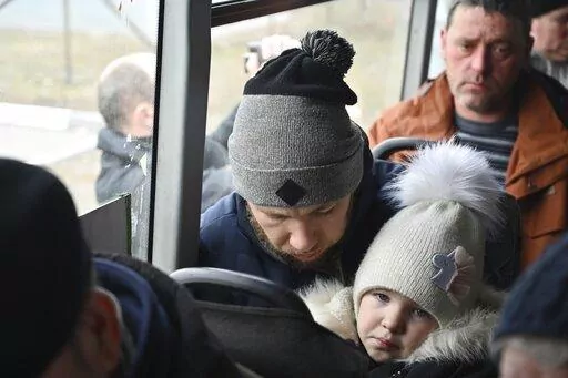 Refugees fleeing fleeing the military operation zone from the Mariupol area of Ukraine sit in a bus as they arrive at the border crossing in Veselo-Voznesenka, Russia, Monday, March 7, 2022. Russia announced yet another limited cease-fire and the establishment of safe corridors to allow civilians to flee some besieged Ukrainian cities. (AP Photo)