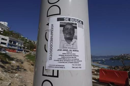 A missing persons sign with the hashtag "otis disappeared" covers a post in Acapulco, Mexico, Sunday, Nov. 12, 2023. It was 12:20 a.m. on Oct. 25. when Hurricane Otis made landfall in this Pacific port city as a Category 5 hurricane, leaving 48 dead, mostly by drowning, and 31 missing, according to official figures. Sailors, fishermen and relatives of crew members believe that there may be more missing because sailors often go to take care of their yachts when a storm approaches. (AP Photo/Marco