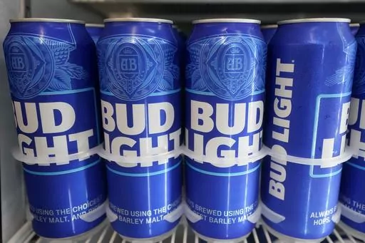 FILE-Cans of Bud Light chill in a refrigerator in Oakland, Calif., Friday, April 28, 2023. AB InBev reports earnings on Tuesday, Oct. 31. (AP Photo/Jeff Chiu)