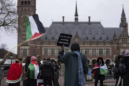 Pro-Palestinians demonstrators wave flags as they protest outside the United Nations' highest court during historic hearings, in The Hague, Netherlands, Monday, Feb. 19, 2024. The Palestinian foreign minister has accused Israel of apartheid and urged the United Nations’ top court to declare that Israel’s occupation of lands sought for a Palestinian state is illegal. If the situation endures, the Palestinians say that any hope for a two-state future will die. The allegation came at the start 