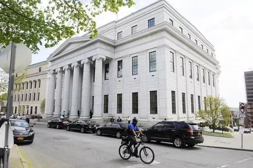 A cyclist rides past the New York Court of Appeals, May 5, 2015, in Albany, N.Y. New York’s highest court on Tuesday, Dec. 12, 2023, ordered the state to draw new congressional districts ahead of the 2024 elections, giving Democrats a potential advantage in what is expected to be a battleground for control of the U.S. House. (AP Photo/Hans Pennink, File)