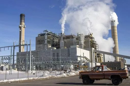 Carbon dioxide and other pollutants billows from stacks at the Naughton Power Plant, near where Bill Gates company, TerraPower plans to build an advanced, nontraditional nuclear reactor, on Jan. 12, 2022, in Kemmerer, Wyo. A major economic bill headed to the president has “game-changing” incentives for the nuclear energy industry, experts say, and those tax credits are even more substantial if a facility is sited in a community where a coal plant is closing. (AP Photo/Natalie Behring, File)