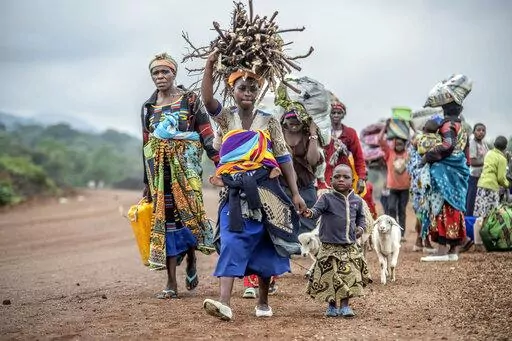 Residents flee fighting between M23 rebels and Congolese forces near Kibumba, some 20 kms ( 12 miles) North of Goma, Democratic republic of Congo, on Oct. 29, 2022. The accounts are haunting. Abductions, torture, rapes. Scores of civilians including women and children have been killed by the M23 rebels in eastern Congo, according to a U.N. report expected to be published this week. (AP Photo/Moses Sawasawa, File)