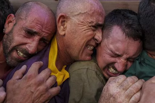 "Costaleros", who carry on their backs the portable dais platform which supports a statue of Jesus Christ of the "Padre Jesus Nazareno" brotherhood, participate in the holy week procession in Priego de Cordoba, southern Spain, Friday, April 7, 2023. Hundreds of processions take place throughout Spain during the Easter Holy Week. (AP Photo/Manu Fernandez)