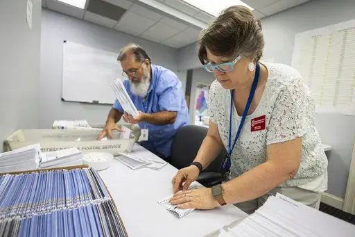 Dawn Stephens, right, and Duane Taylor prepare ballots to be mailed at the Mecklenburg County Board of Elections in Charlotte, N.C., Sept. 5, 2024. (AP Photo/Nell Redmond, File)