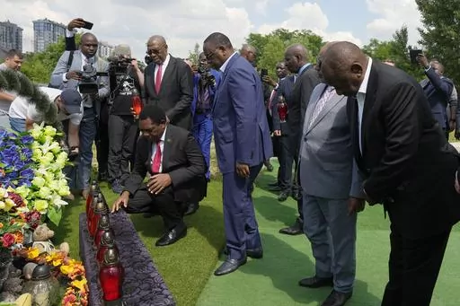 From right, South African President Cyril Ramaphosa, President of the Union of Comoros Azali Assoumani, Senegal's President Macky Sall, and Zambia's President Hakainde Hichilema, bottom, attend a commemoration ceremony at a site of a mass grave in Bucha, on the outskirts of Kyiv, Ukraine, Friday, June 16, 2023. South African President Cyril Ramaphosa arrived in Ukraine on Friday as part of a delegation of African leaders and senior officials seeking ways to end Kyiv's 15-month war with Russia. (