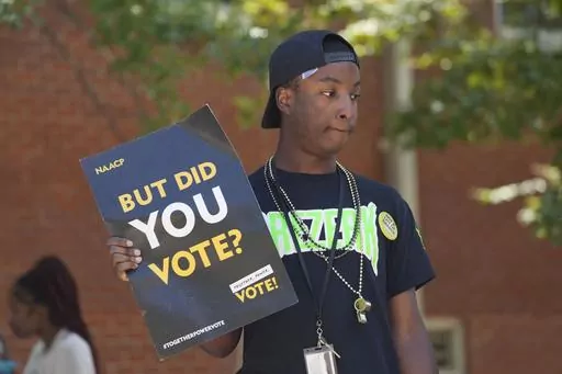 A Jackson State University student holds a sign stressing the importance of voting during a JSU Votes Civic Engagement Initiative on National Voter Registration Day, Sept. 19, 2023, on the Jackson, Miss., campus. According to information from the Mississippi Secretary of State's Office, the number of registered voters in the state has remained steady during the months leading to the Nov. 7 election for governor and other offices. (AP Photo/Rogelio V. Solis, File)