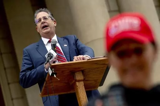 Matthew DePerno, Republican candidate for Michigan attorney general, speaks during a rally at the Michigan state Capitol, Oct. 12, 2021, in Lansing, Mich. A former Republican attorney general candidate and another supporter of former President Donald Trump have been criminally charged in Michigan in connection with accessing and tampering with voting machines after the 2020 election. DePerno, a lawyer who was endorsed by Trump in an unsuccessful run for Michigan attorney general last year, was a