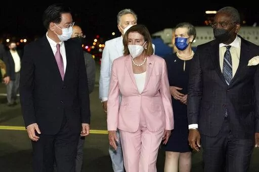 In this photo released by the Taiwan Ministry of Foreign Affairs, U.S. House Speaker Nancy Pelosi, center, walks with Taiwan's Foreign Minister Joseph Wu, left, as she arrives in Taipei, Taiwan, Tuesday, Aug. 2, 2022. Pelosi arrived in Taiwan on Tuesday night despite threats from Beijing of serious consequences, becoming the highest-ranking American official to visit the self-ruled island claimed by China in 25 years. ( Taiwan Ministry of Foreign Affairs via AP)