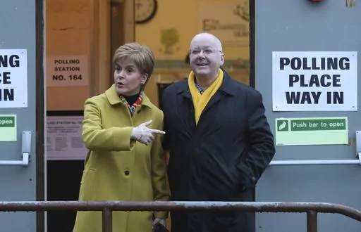 Scottish First Minister Nicola Sturgeon poses for the media with husband Peter Murrell, outside polling station in Glasgow, Scotland, on Dec. 12, 2019. Scotland police say the treasurer of the Scottish National Party has been arrested in a party finance probe. Colin Beattie, a member of Scottish Parliament, was arrested Tuesday, April 18, 2023 in an investigation into how 600,000 pounds ($745,000) designated for a Scottish independence campaign was spent. The arrest comes two weeks after the par