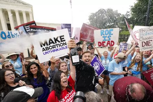 A celebration outside the Supreme Court, Friday, June 24, 2022, in Washington. The Supreme Court has ended constitutional protections for abortion that had been in place nearly 50 years — a decision by its conservative majority to overturn the court's landmark abortion cases. (AP Photo/Steve Helber)