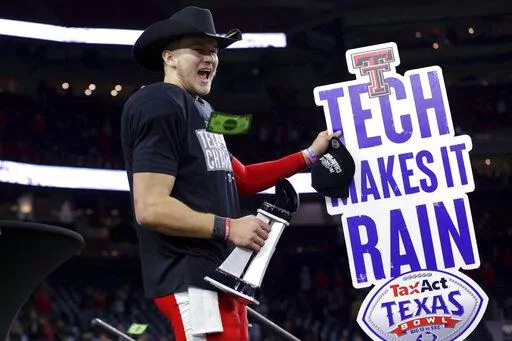 Texas Tech quarterback Tyler Shough waves a sign after the team's 42-25 win over Mississippi in the Texas Bowl NCAA college football game, early Thursday, Dec. 29, 2022, in Houston. (AP Photo/Michael Wyke)