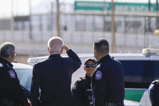 President Joe Biden, second from left, looks towards a large "Welcome to Mexico" sign that is hung over the Bridge of the Americas as he tours the El Paso port of entry, a busy port of entry along the U.S.-Mexico border, in El Paso Texas, Sunday, Jan. 8, 2023. (AP Photo/Andrew Harnik, File)
