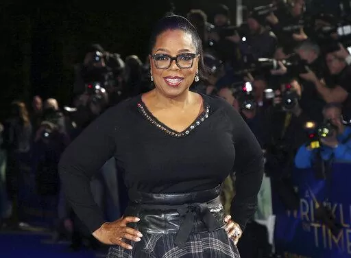 In this March 13, 2018, file photo, actress Oprah Winfrey poses for photographers upon arrival at the premiere of the film "A Wrinkle In Time" in London. Winfrey and the Smithsonian Channel are partnering up to highlight the racial disparities in the healthcare system through a new campaign and documentary. The network revealed on Thursday the Color of Care campaign to create a solution toward health equity. The campaign will follow the premiere of Winfrey’s “The Color of Care” documentary