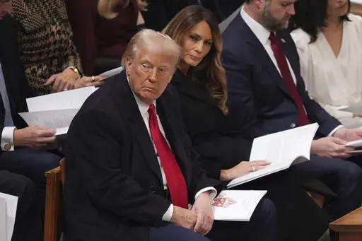 President Donald Trump, left, and first lady Melania Trump attend the national prayer service at the Washington National Cathedral, Tuesday, Jan. 21, 2025, in Washington. (AP Photo/Evan Vucci)