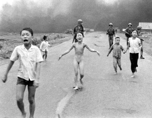 South Vietnamese forces follow terrified children, including 9-year-old Kim Phuc, center, as they run down Route 1 near Trang Bang after an aerial napalm attack on suspected Viet Cong hiding places on June 8, 1972. A South Vietnamese plane accidentally dropped its flaming napalm on South Vietnamese troops and civilians, and the terrified girl had ripped off her burning clothes while fleeing. (AP Photo/Nick Ut, File)