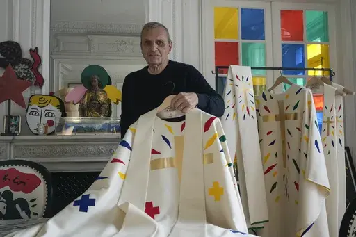 Designer Jean-Charles de Castelbajac displays a liturgical vestment for bishops to be worn at the reopening of Paris' Notre-Dame Cathedral in December, Wednesday, Nov. 20, 2024 in Paris. (AP Photo/Michel Euler)